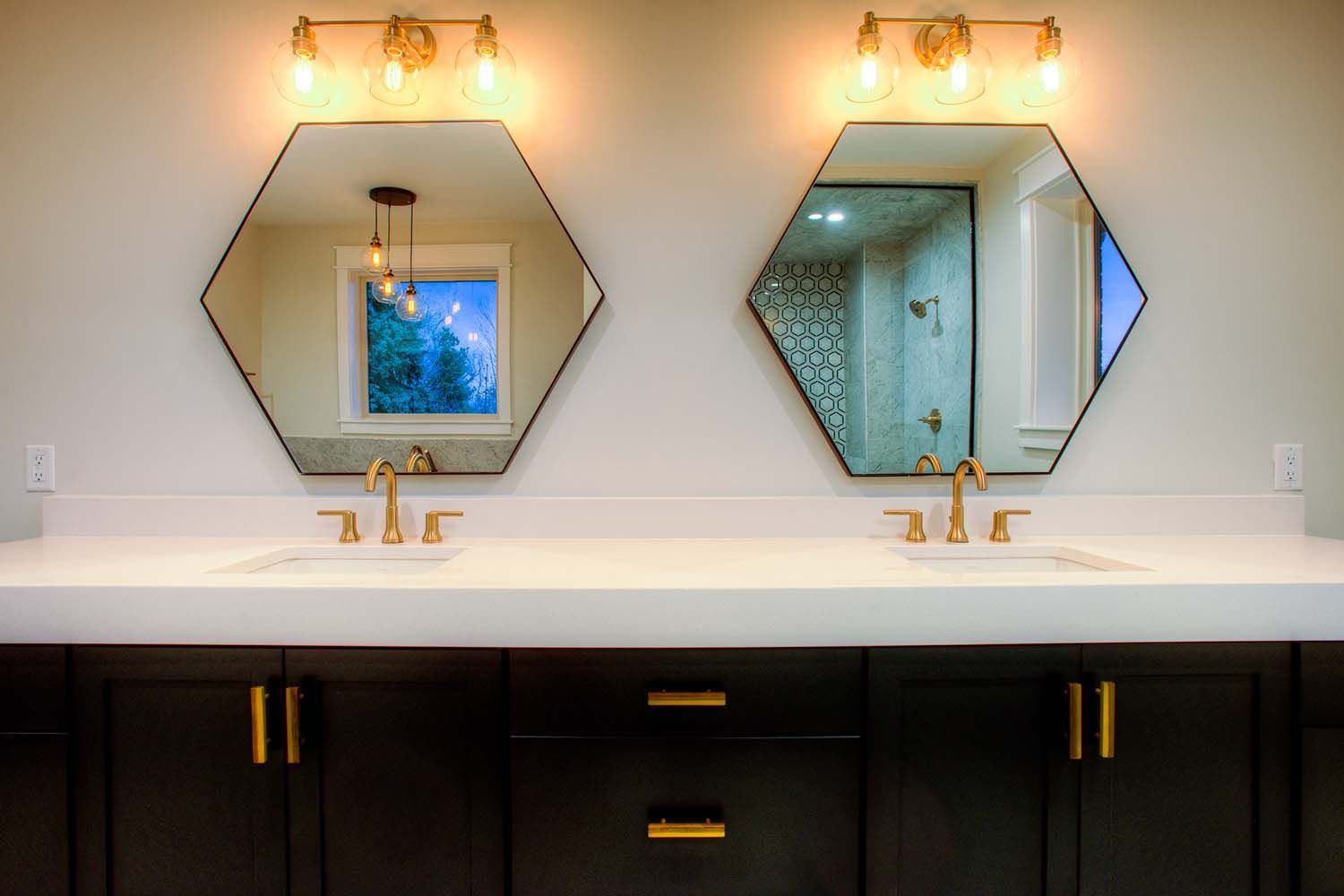 A bathroom with two sinks and two mirrors.