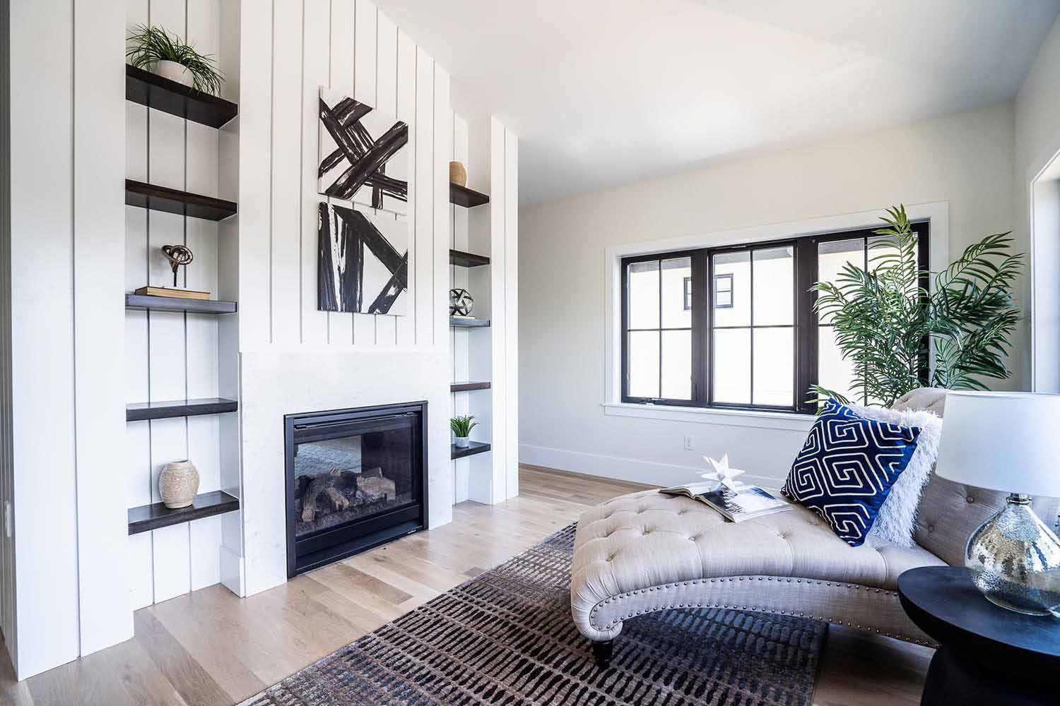 A living room with a fireplace and a chaise lounge.