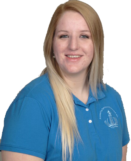 A woman wearing a blue polo shirt is smiling for the camera.