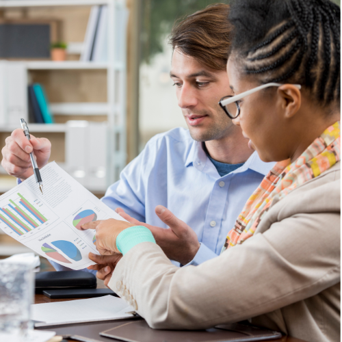 A man and a woman are looking at a piece of paper