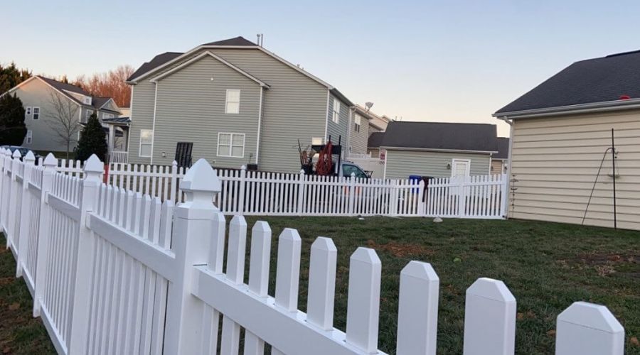 White vinyl picket fence installation in a Kings Mountain NC neighborhood.