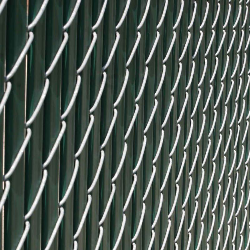 Green chain-link fence with vertical green posts and a white, diamond-shaped pattern.