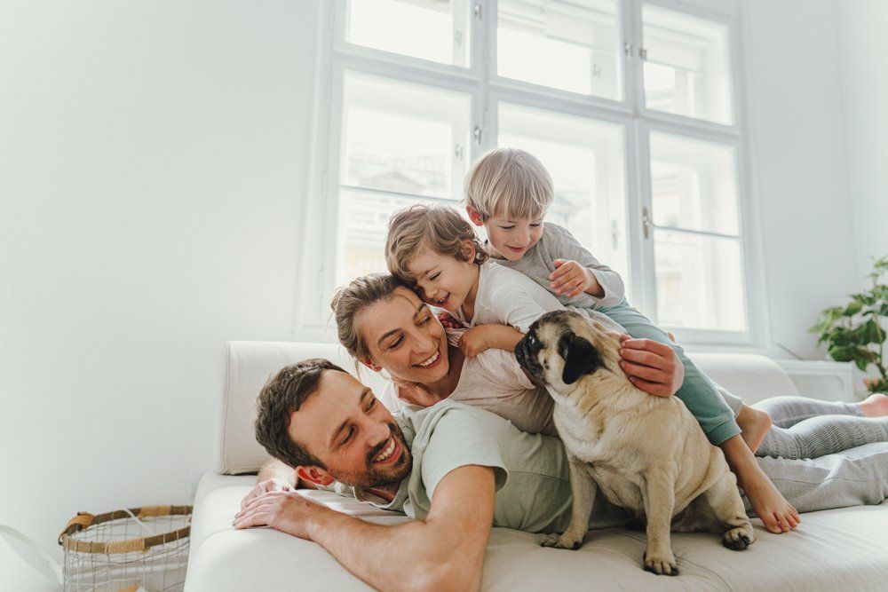 Cheerful Family With A Dog — Aurora, CO — Katherine Moskal Health Plans Cheerful Family With A Dog — Aurora, CO — Katherine Moskal Health Plans