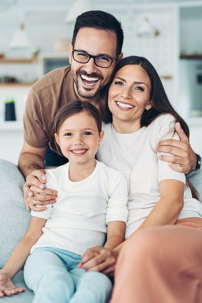 Smiling Family At Home — Aurora, CO — Katherine Moskal Health Plans Smiling Family At Home — Aurora, CO — Katherine Moskal Health Plans