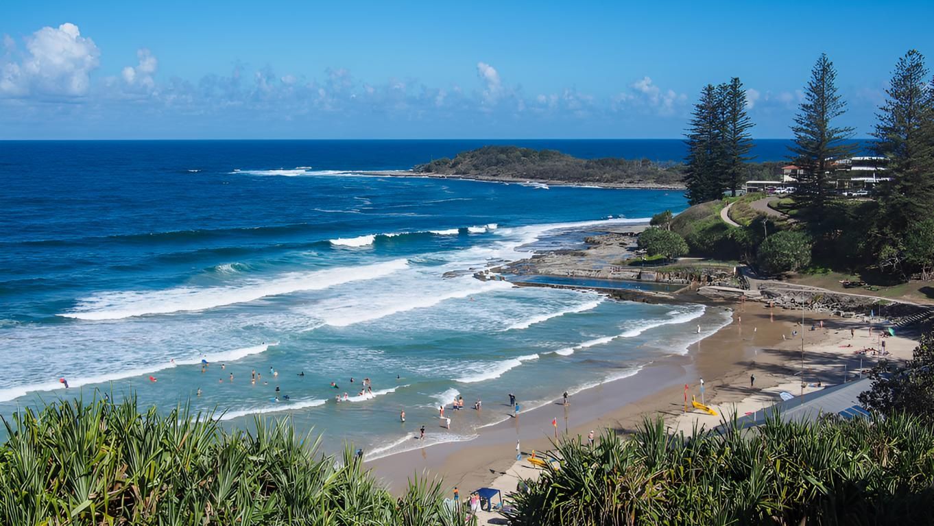 A Beach With a Lot of People Swimming in the Ocean — Coastal Test & Tag in Grafton, NSW