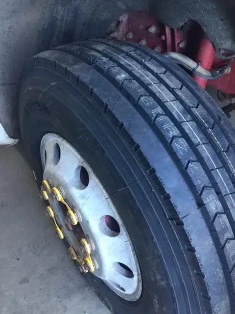 A Close-up of a Heavy-duty Truck Tire With a Silver Rim — Mid North Coast Heavy Vehicle Repairs In Wauchope, NSW