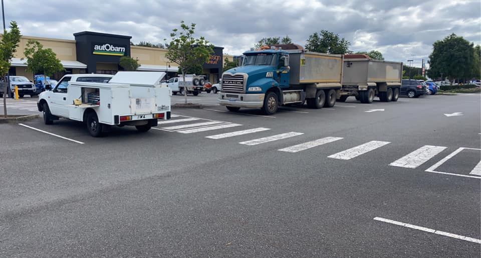 A Service Truck and a Semi-truck Parked in a Retail Parking Lot — Mid North Coast Heavy Vehicle Repairs In Wauchope, NSW