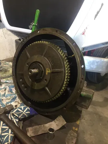 A Metal Flywheel With Gear Teeth Attached to a Circular Housing — Mid North Coast Heavy Vehicle Repairs In Wauchope, NSW