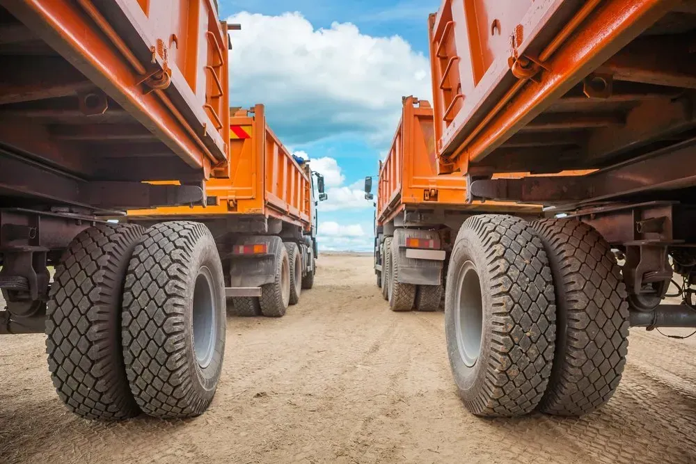 Two Orange Dump Trucks Parked Side-by-side — Mid North Coast Heavy Vehicle Repairs In Wauchope, NSW