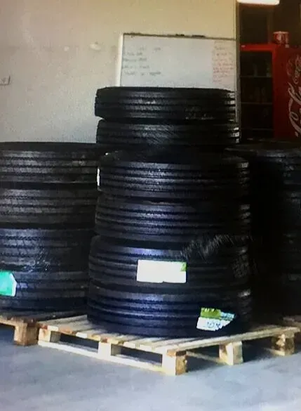Stacked Black Tires Rest on a Wooden Pallet — Mid North Coast Heavy Vehicle Repairs In Wauchope, NSW
