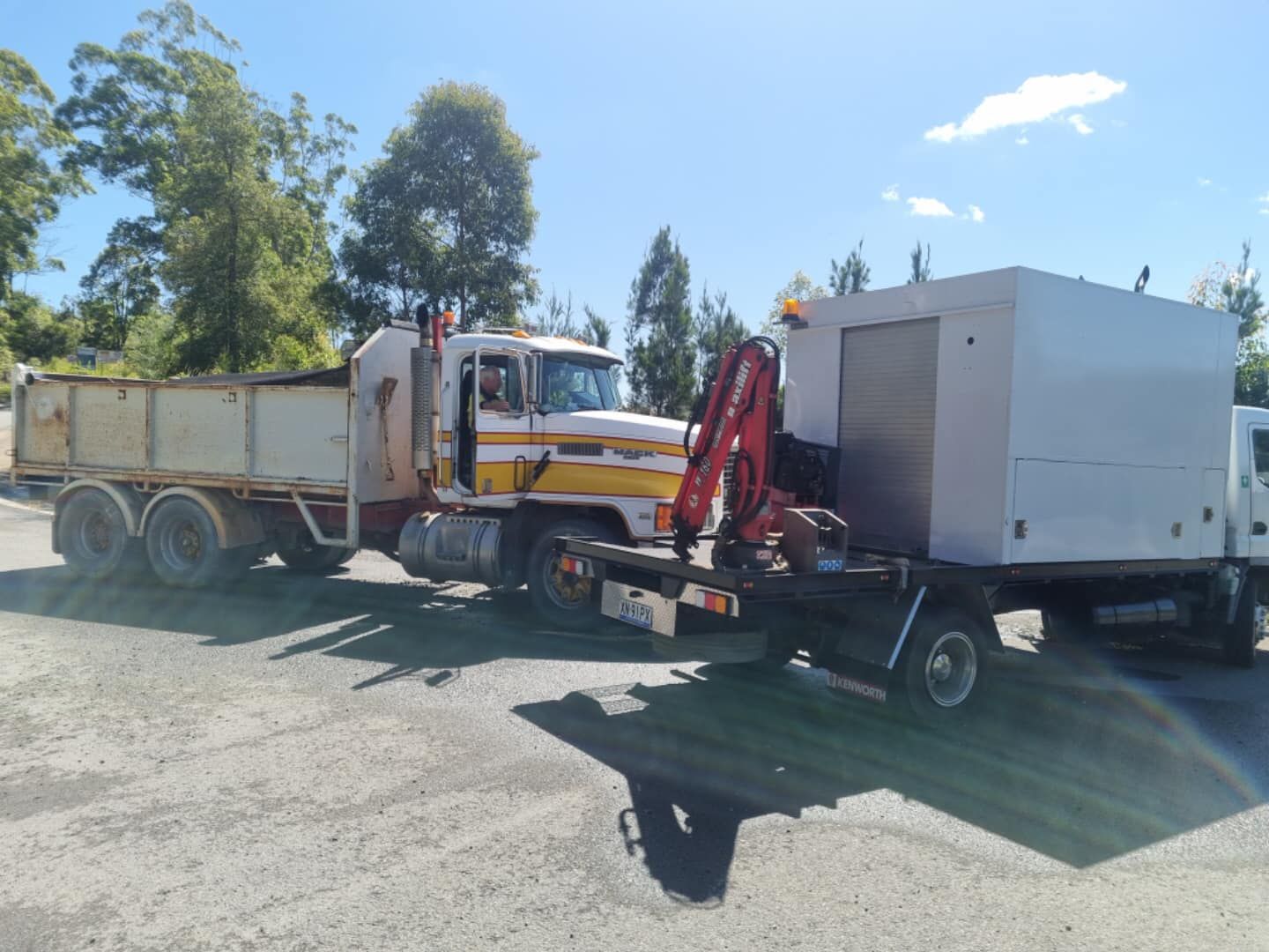 A White Truck Parked Next to a Large Dump Truck — Mid North Coast Heavy Vehicle Repairs In Lake Cathie, NSW