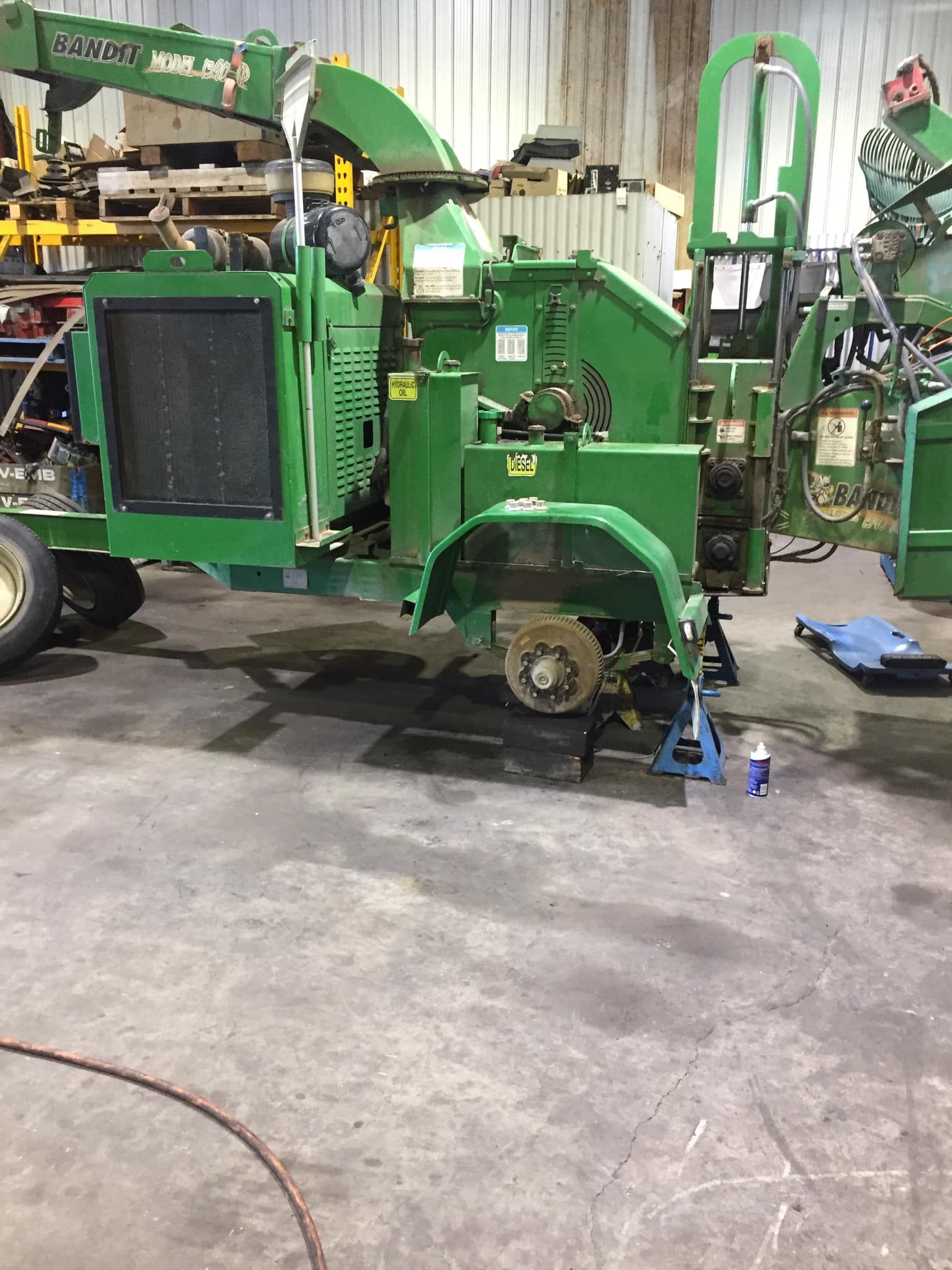 A Green Industrial Wood Chipper Sits on a Concrete Shop Floor — Mid North Coast Heavy Vehicle Repairs In Taree, NSW