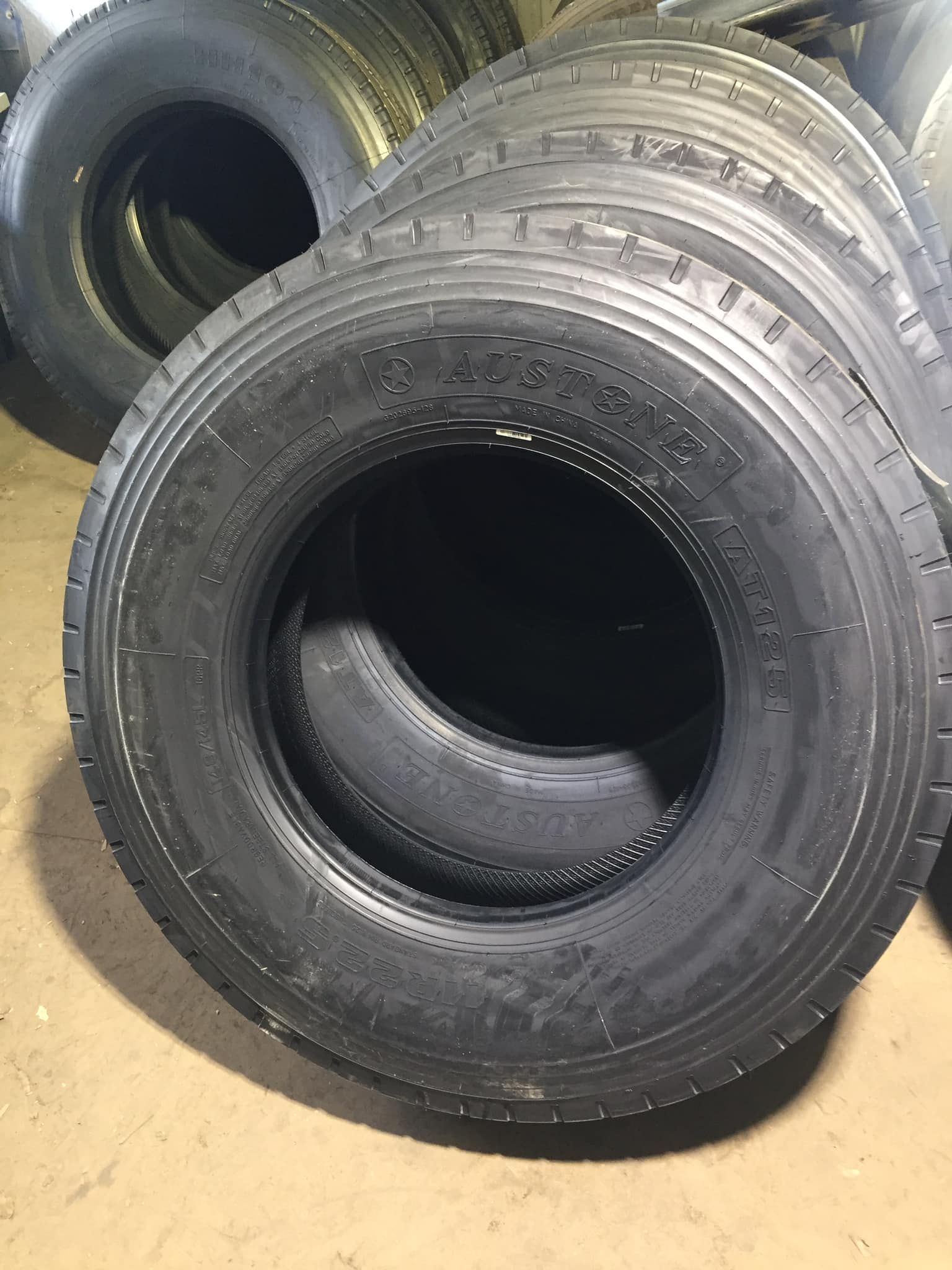 A Stack of Black, New Rubber Tires Resting on a Concrete Floor — Mid North Coast Heavy Vehicle Repairs In Kempsey, NSW