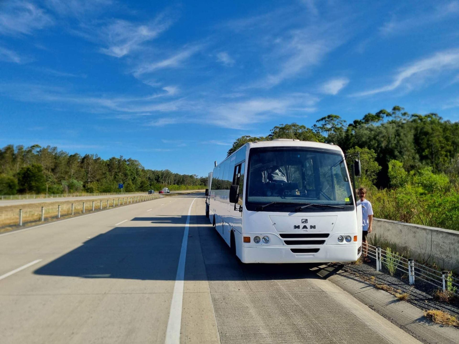 A White Tour Bus Parked on the Shoulder of a Highway — Mid North Coast Heavy Vehicle Repairs In Bonny Hills, NSW