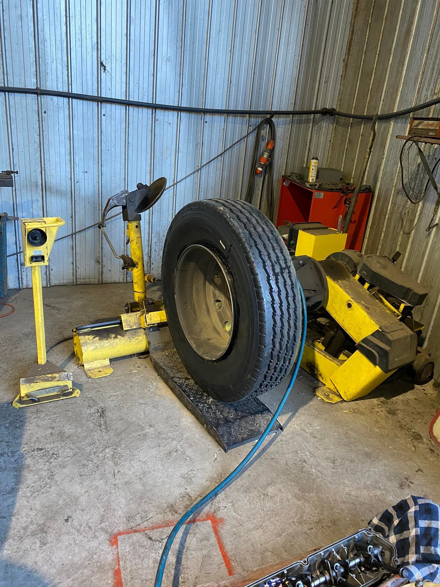 A Large Vehicle Tire Stands Upright in a Workshop — Mid North Coast Heavy Vehicle Repairs In Wauchope, NSW
