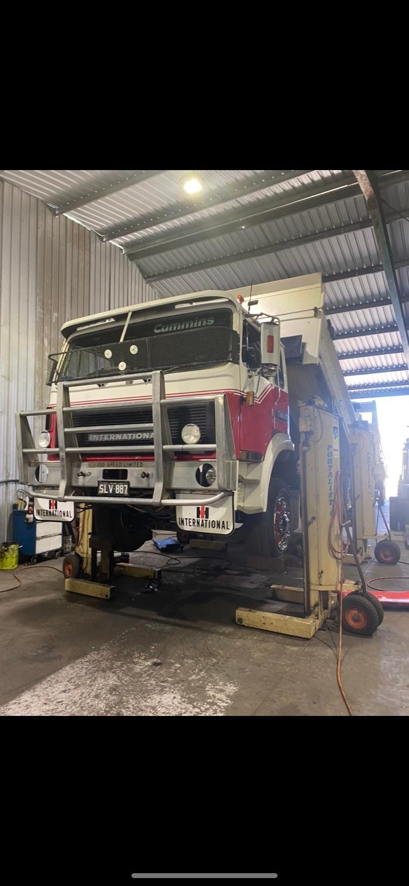 A Fire Engine is Lifted by a Hydraulic Maintenance Hoist — Mid North Coast Heavy Vehicle Repairs In Kempsey, NSW