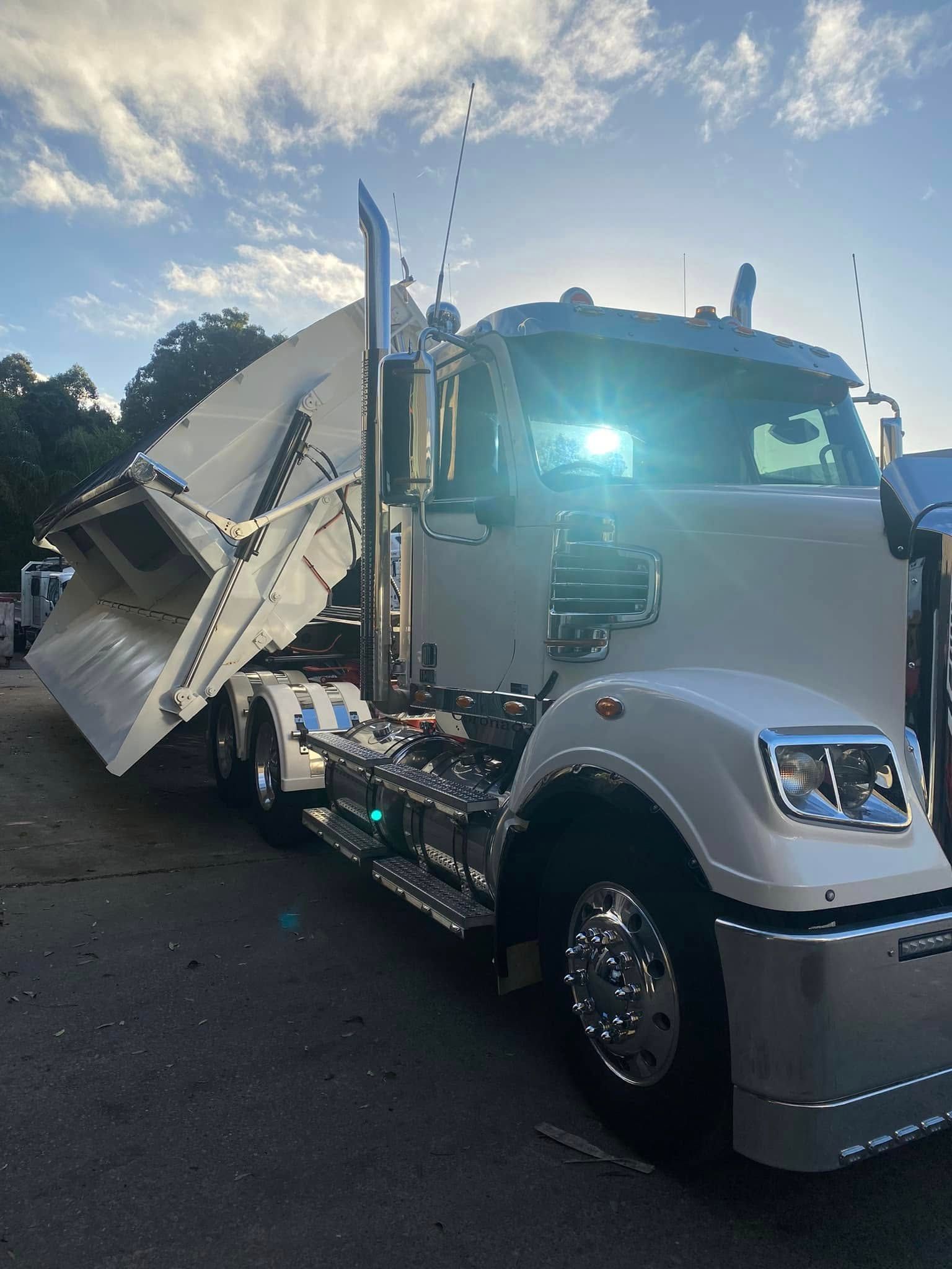 A Semi-truck With a Raised Dump Trailer Parked on an Asphalt Lot — Mid North Coast Heavy Vehicle Repairs In Kew, NSW