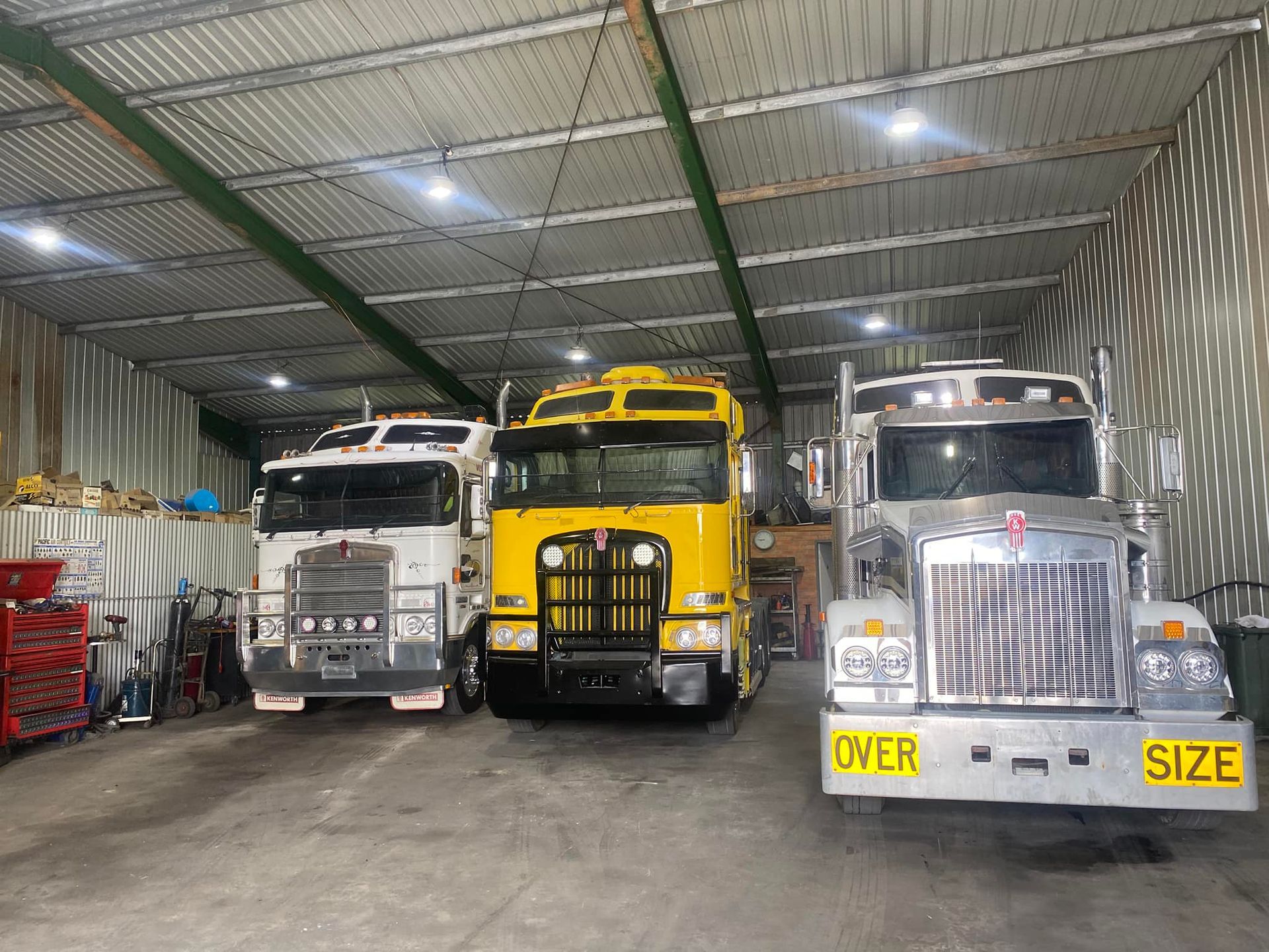 Three Semi-trucks Parked Inside a Large, Industrial Shed — Mid North Coast Heavy Vehicle Repairs In Wauchope, NSW