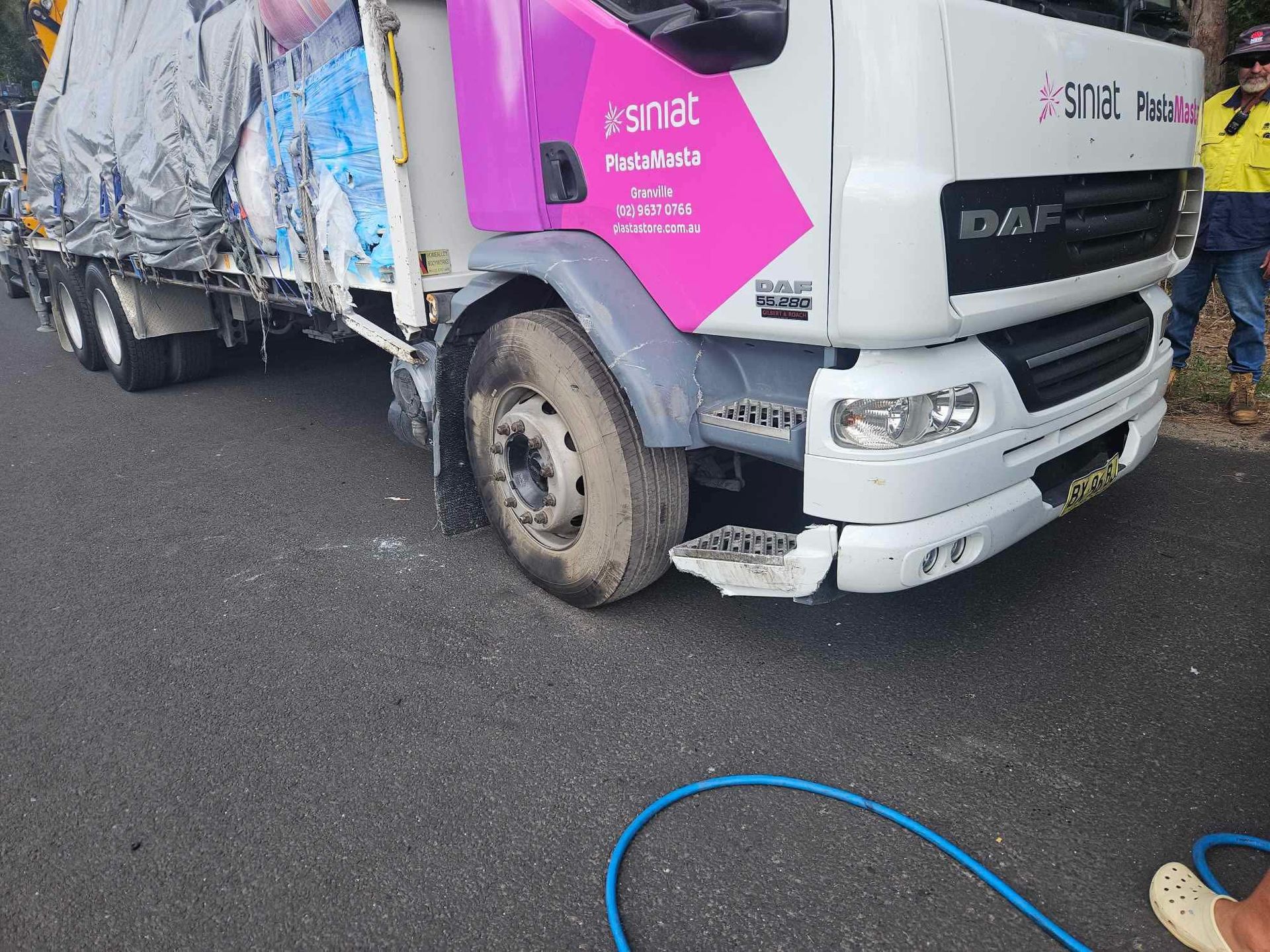 A Truck With Pink Branding Parked on Asphalt — Mid North Coast Heavy Vehicle Repairs In Kew, NSW