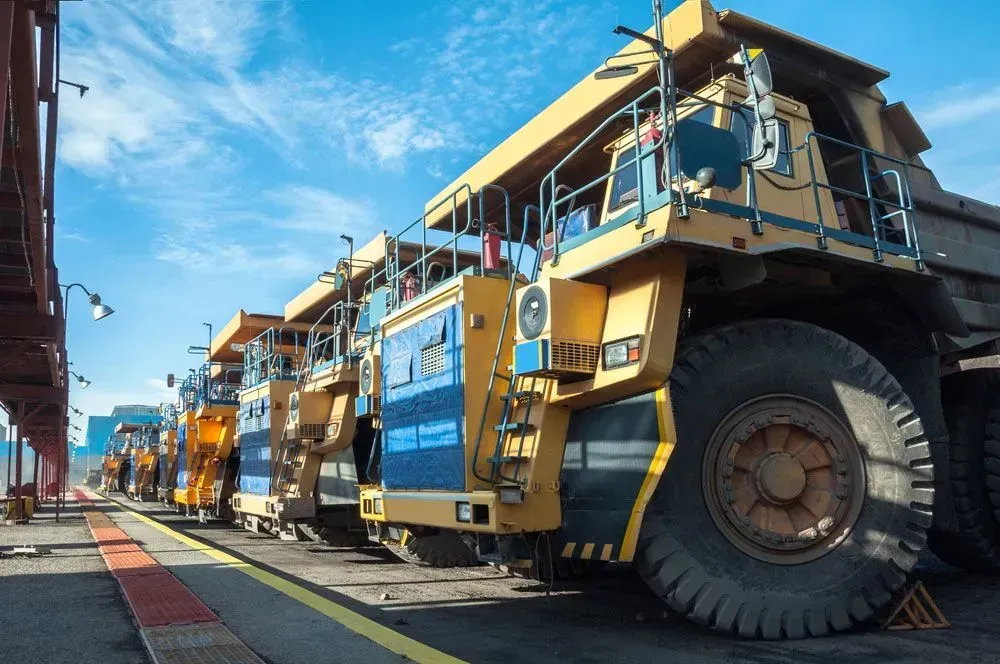A Line of Massive Yellow Industrial Haul Trucks Parked in a Row — Mid North Coast Heavy Vehicle Repairs In Thrumster, NSW