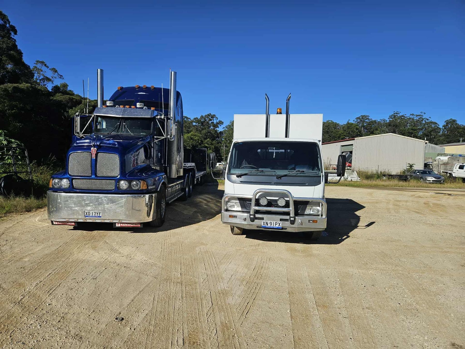 A Semi-truck and a Medium-duty Truck Parked Side-by-side — Mid North Coast Heavy Vehicle Repairs In Thrumster, NSW