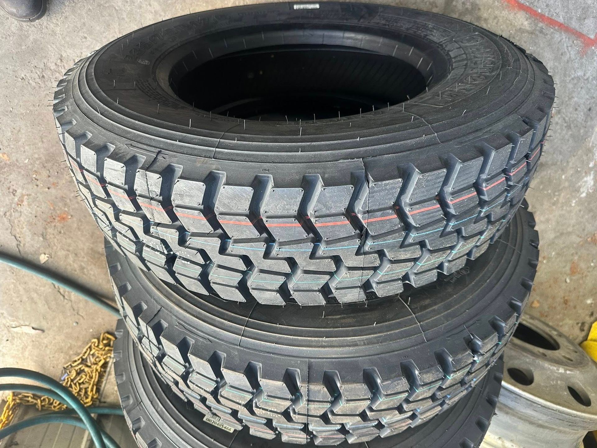 A Stack of Three Black, Heavy-duty Truck Tyres — Mid North Coast Heavy Vehicle Repairs In Thrumster, NSW