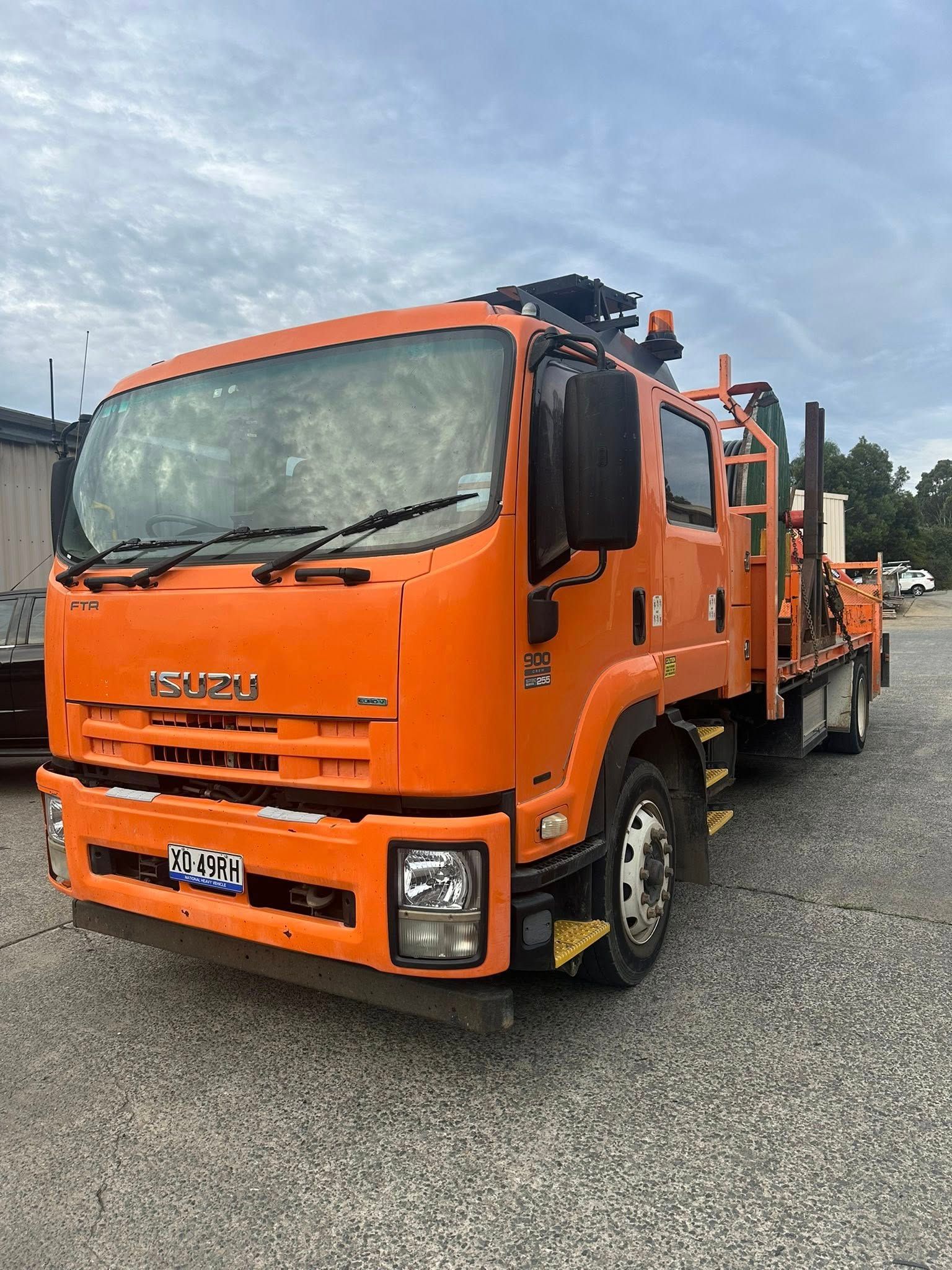 Bright Orange Isuzu Utility Truck Parked — Mid North Coast Heavy Vehicle Repairs In Wauchope, NSW