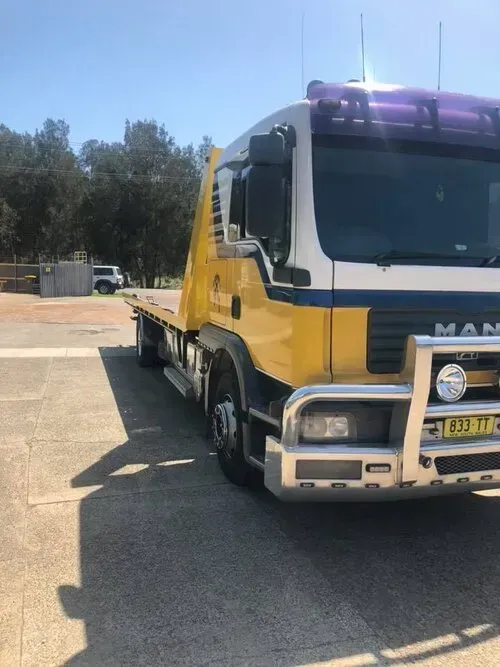 A Yellow and White Man Tow Truck Parked — Mid North Coast Heavy Vehicle Repairs In Wauchope, NSW
