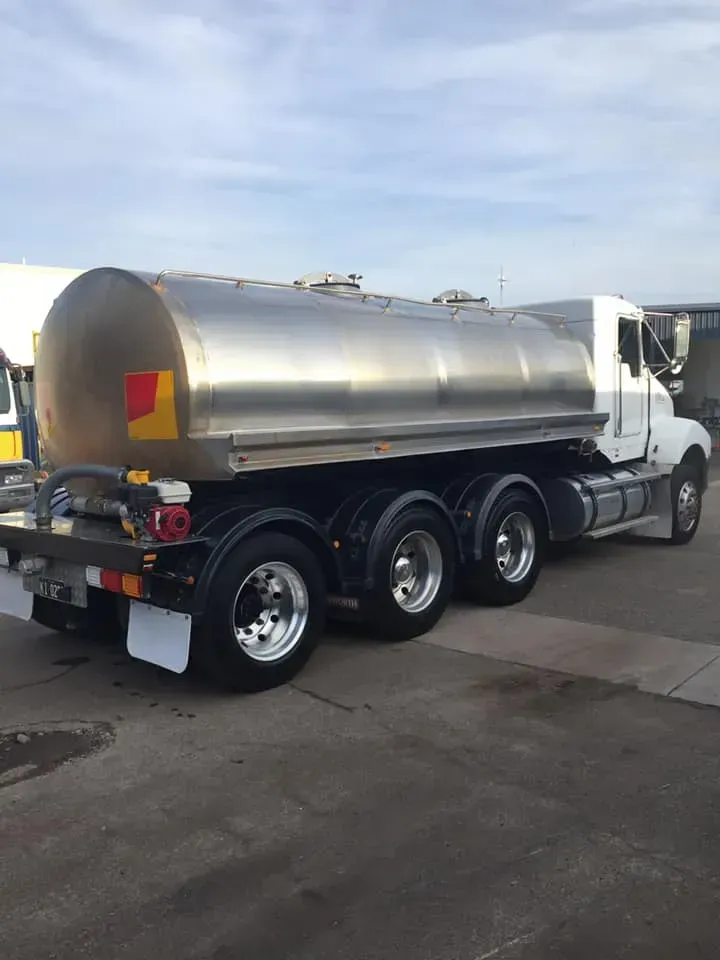 A White Tank Truck Parked on an Asphalt Lot — Mid North Coast Heavy Vehicle Repairs In Wauchope, NSW