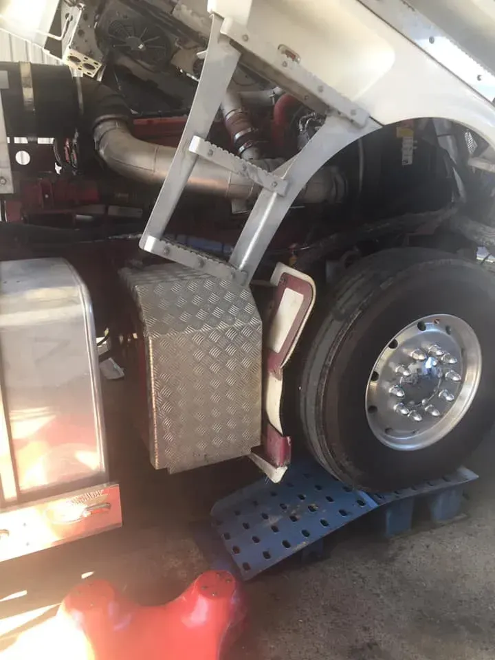 A Semi-truck Front Wheel Resting on a Plastic Ramp — Mid North Coast Heavy Vehicle Repairs In Taree, NSW