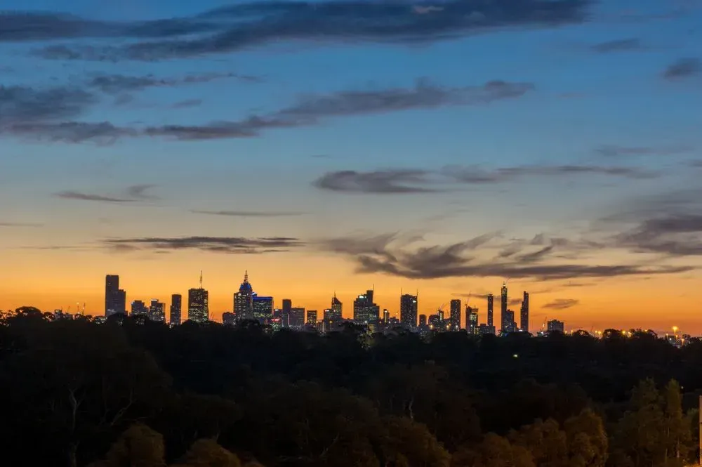 City Skyline Silhouetted Against a Vibrant Orange and Blue Sunset Sky — Mid North Coast Heavy Vehicle Repairs In Kew, NSW
