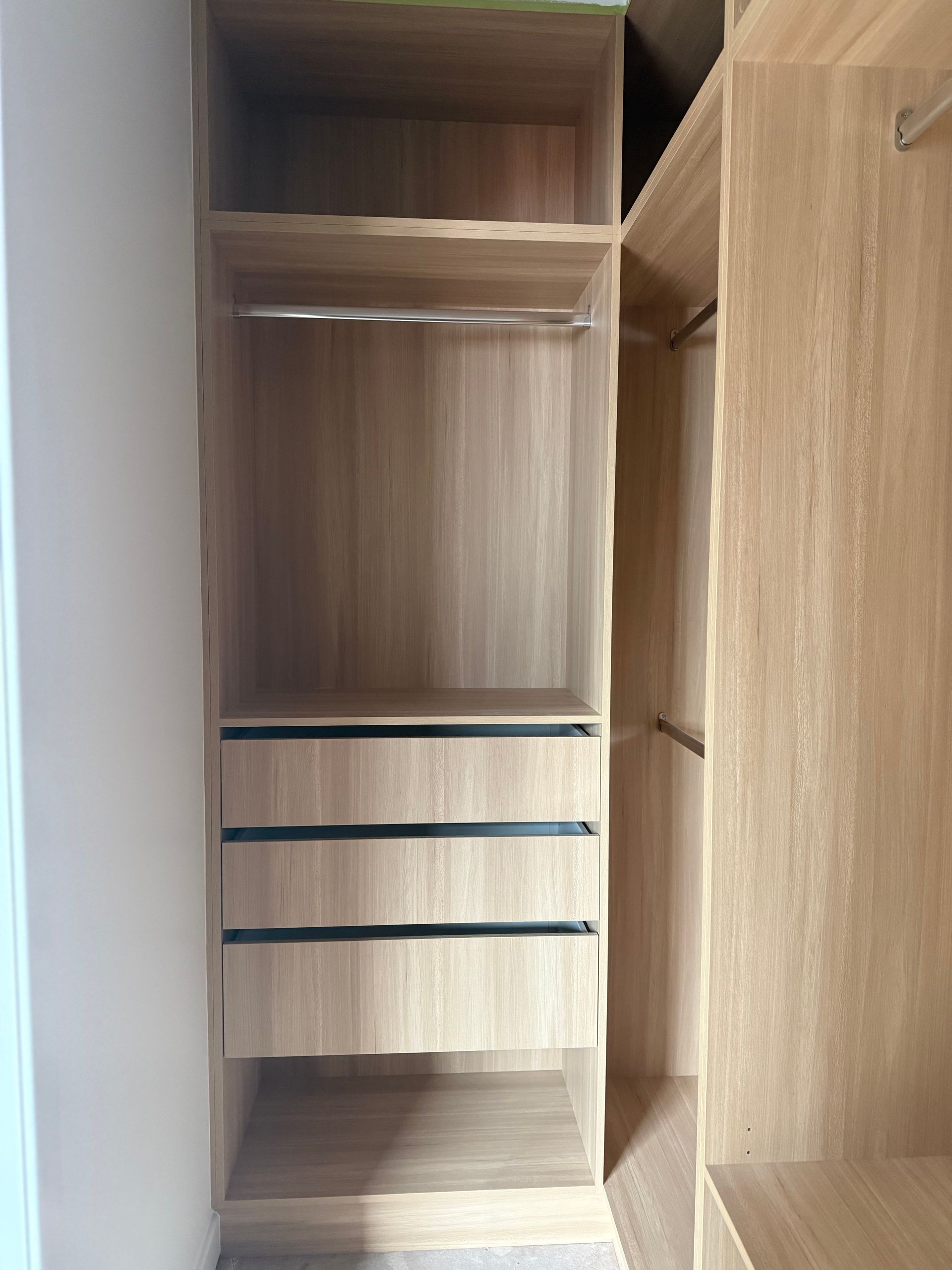 Wooden built-in closet with shelves, drawers, and hanging rods. Light wood colour — Canelo Cabinetry In Rocklea, QLD