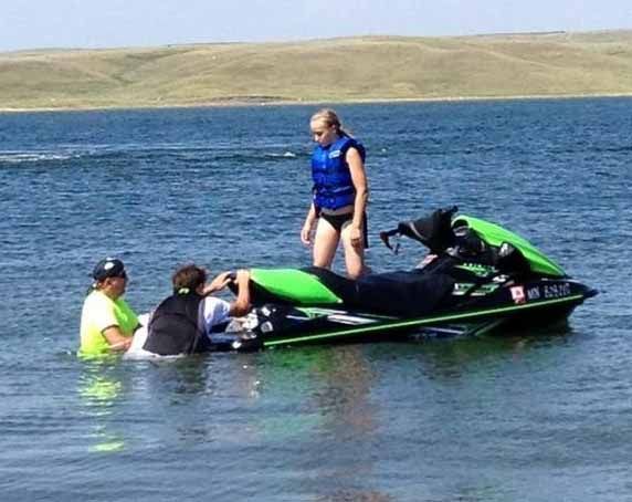 A group of people are on a jet ski in the water