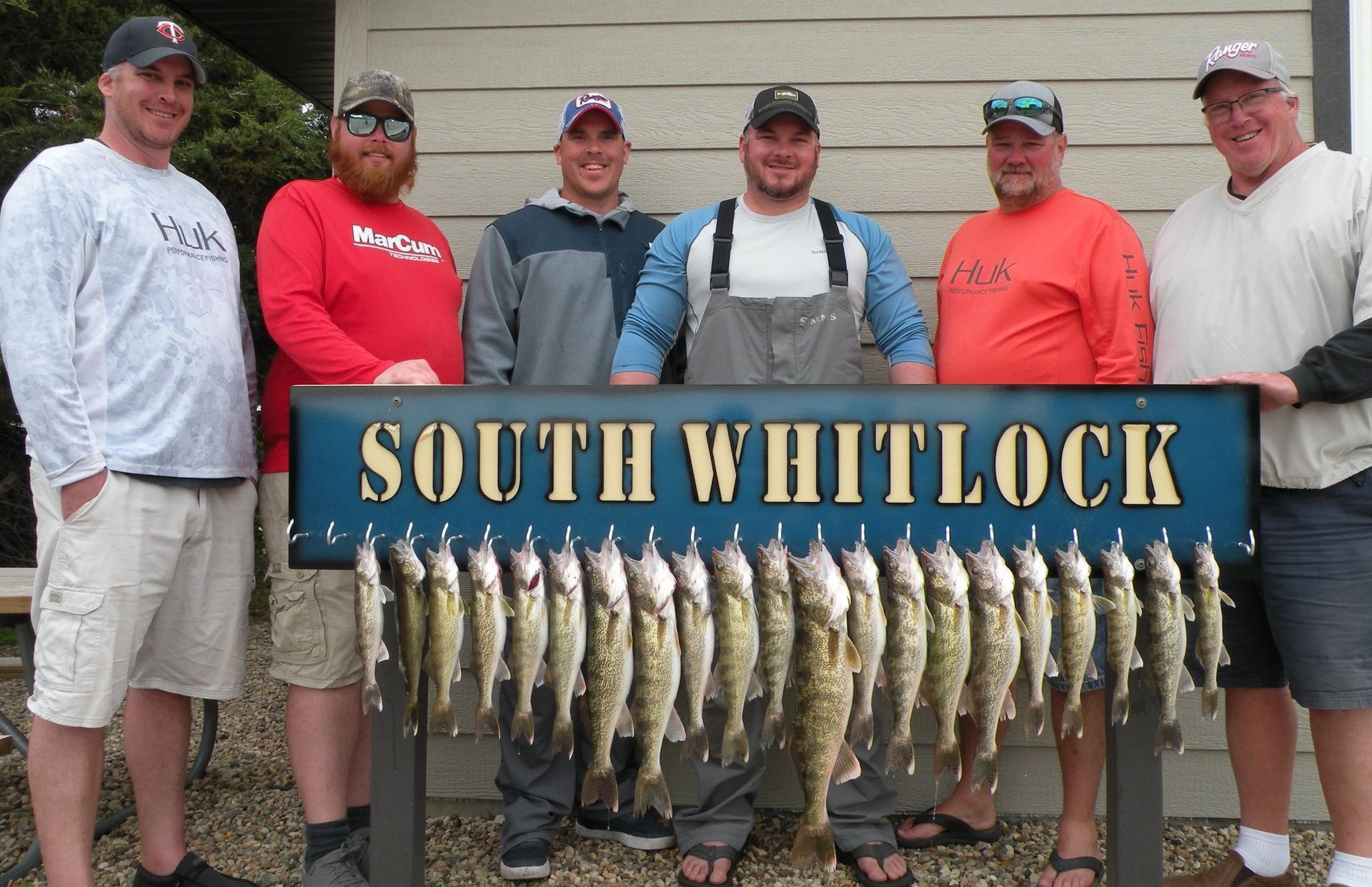 A group of men holding a sign that says south whitlock