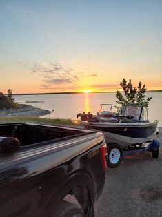 A truck is towing a boat on a trailer.
