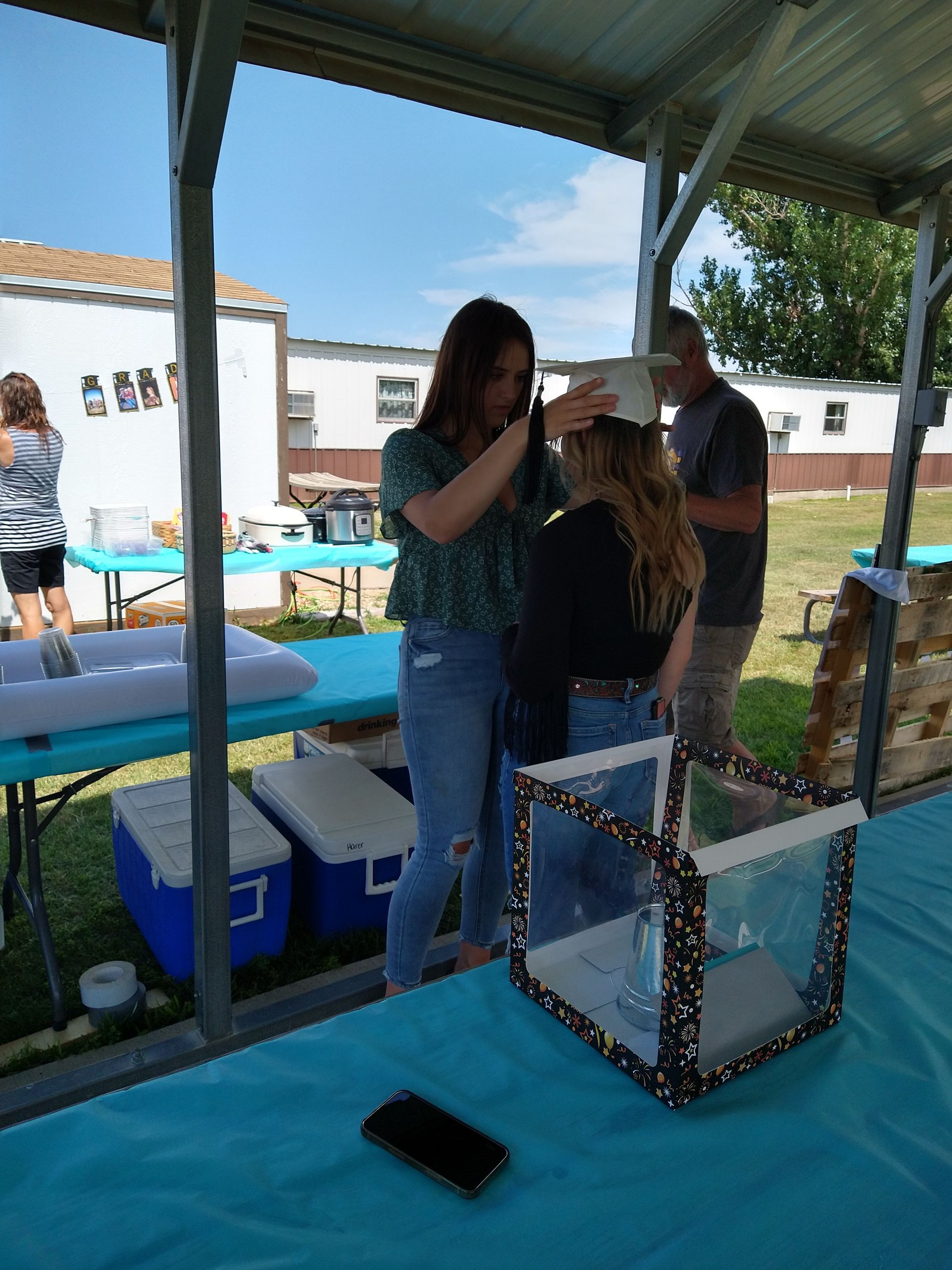 A woman is taking a picture of another woman 's head