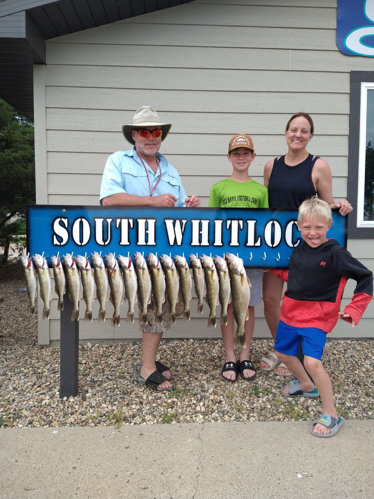 A group of people standing in front of a sign that says south whitlock