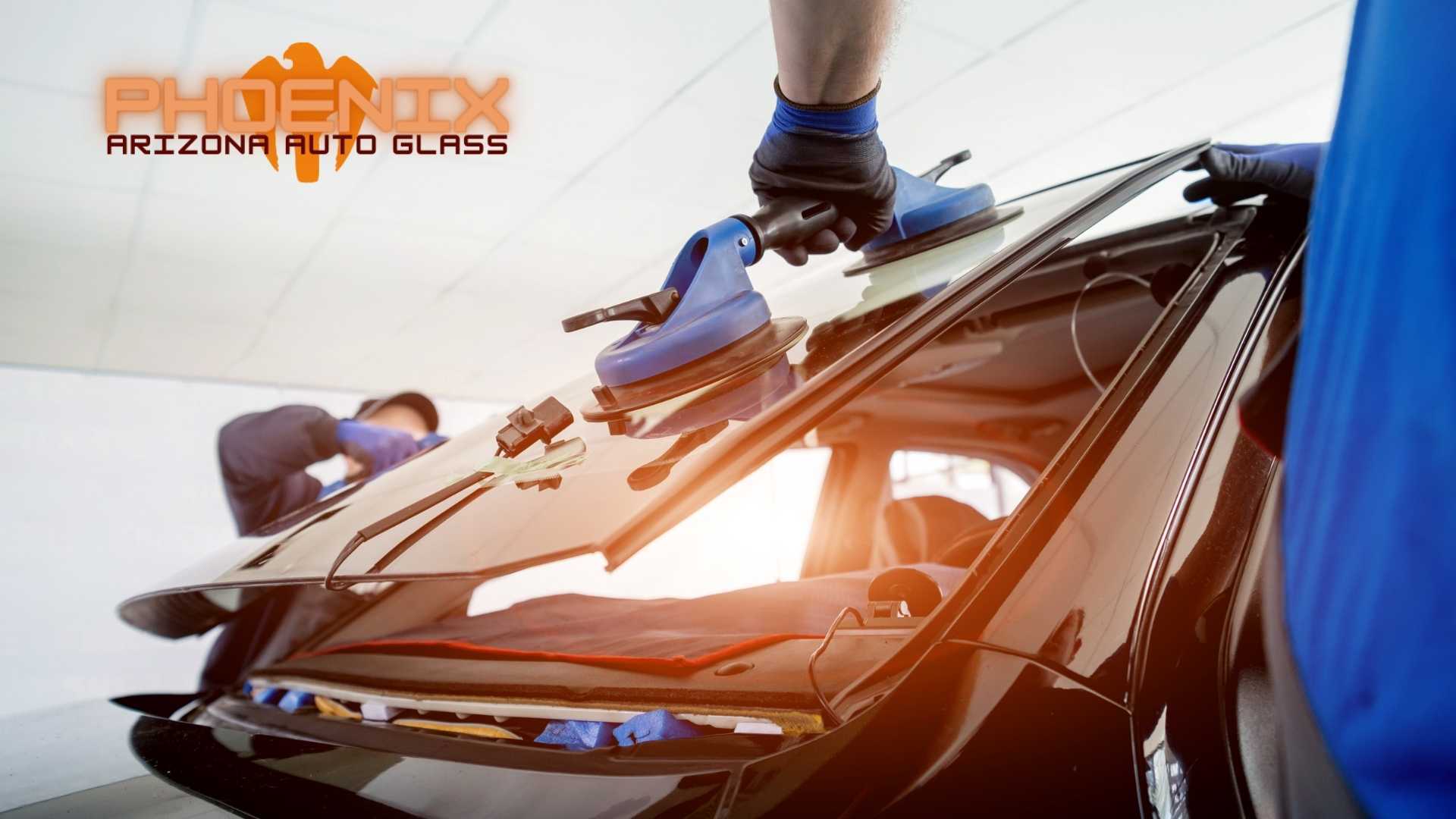 A man is installing a windshield on a car.