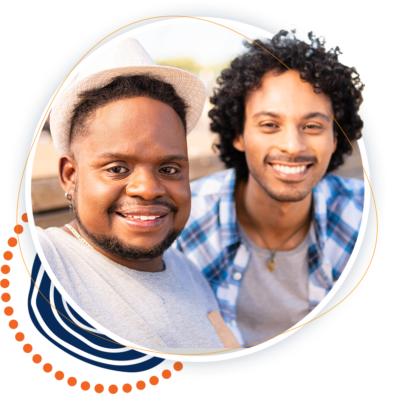 two men sitting next to each other and smiling for the camera
