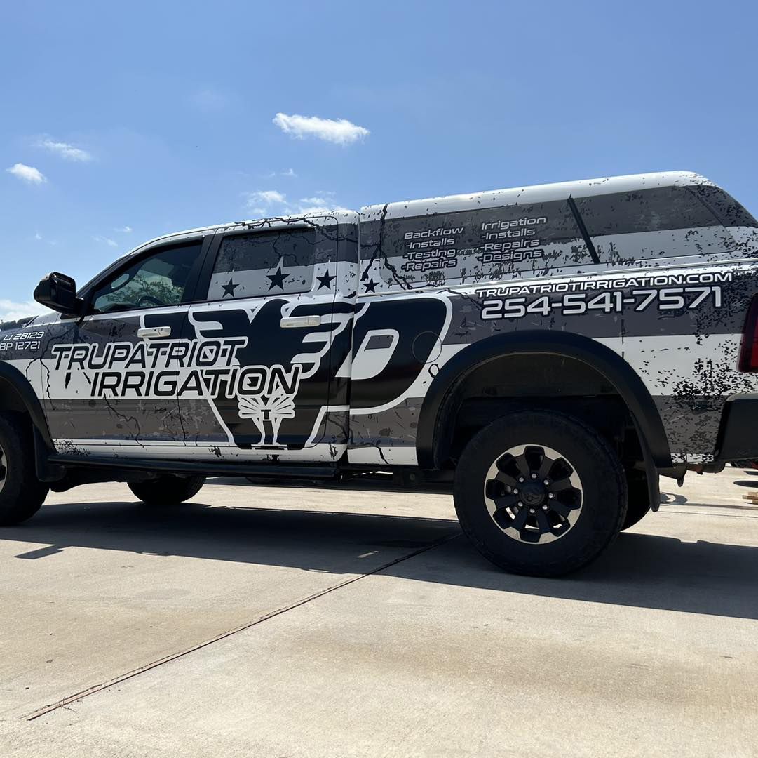 A truck that says trupatriot irrigation on the side