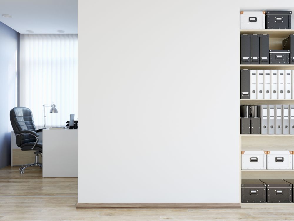 A Room With A Desk , Chair , And Shelves Filled With Binders And Boxes — Wyong Commercial Cleaning In Wyongah, NSW
