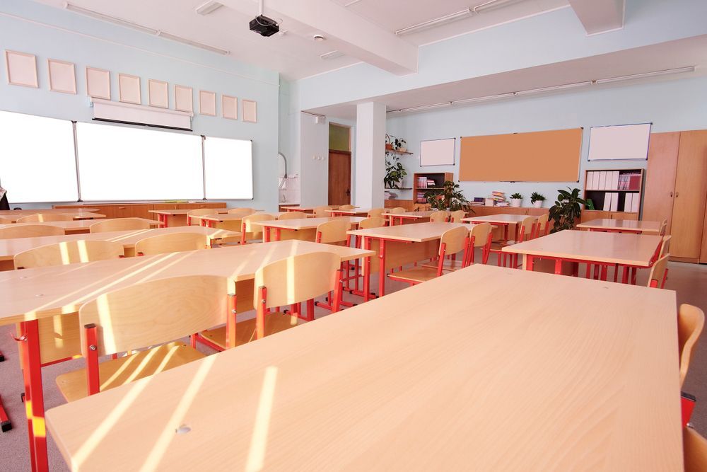 An Empty Classroom With Lots Of Tables And Chairs — Wyong Commercial Cleaning In Wyongah, NSW