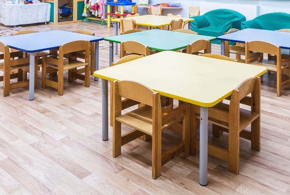 A Row Of Wooden Tables And Chairs In A Classroom — Wyong Commercial Cleaning In Wyongah, NSW