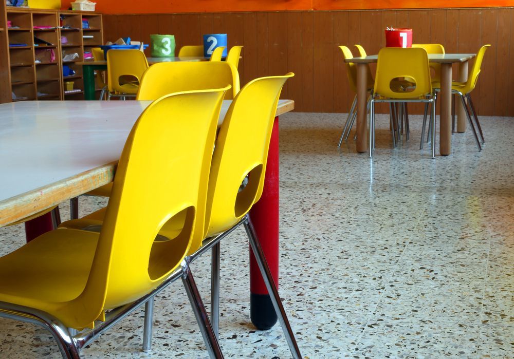 A Classroom With Yellow Chairs And Tables With Numbers On Them — Wyong Commercial Cleaning In Wyongah, NSW