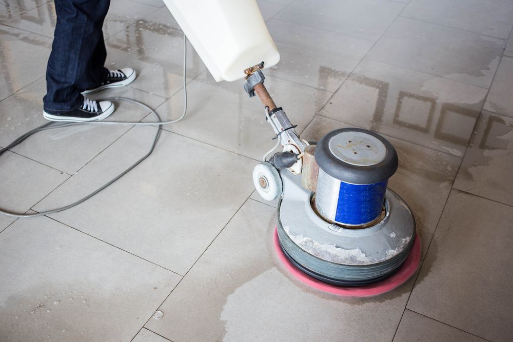 A Person Is Using A Machine To Clean A Tile Floor — Wyong Commercial Cleaning In Morisset, NSW