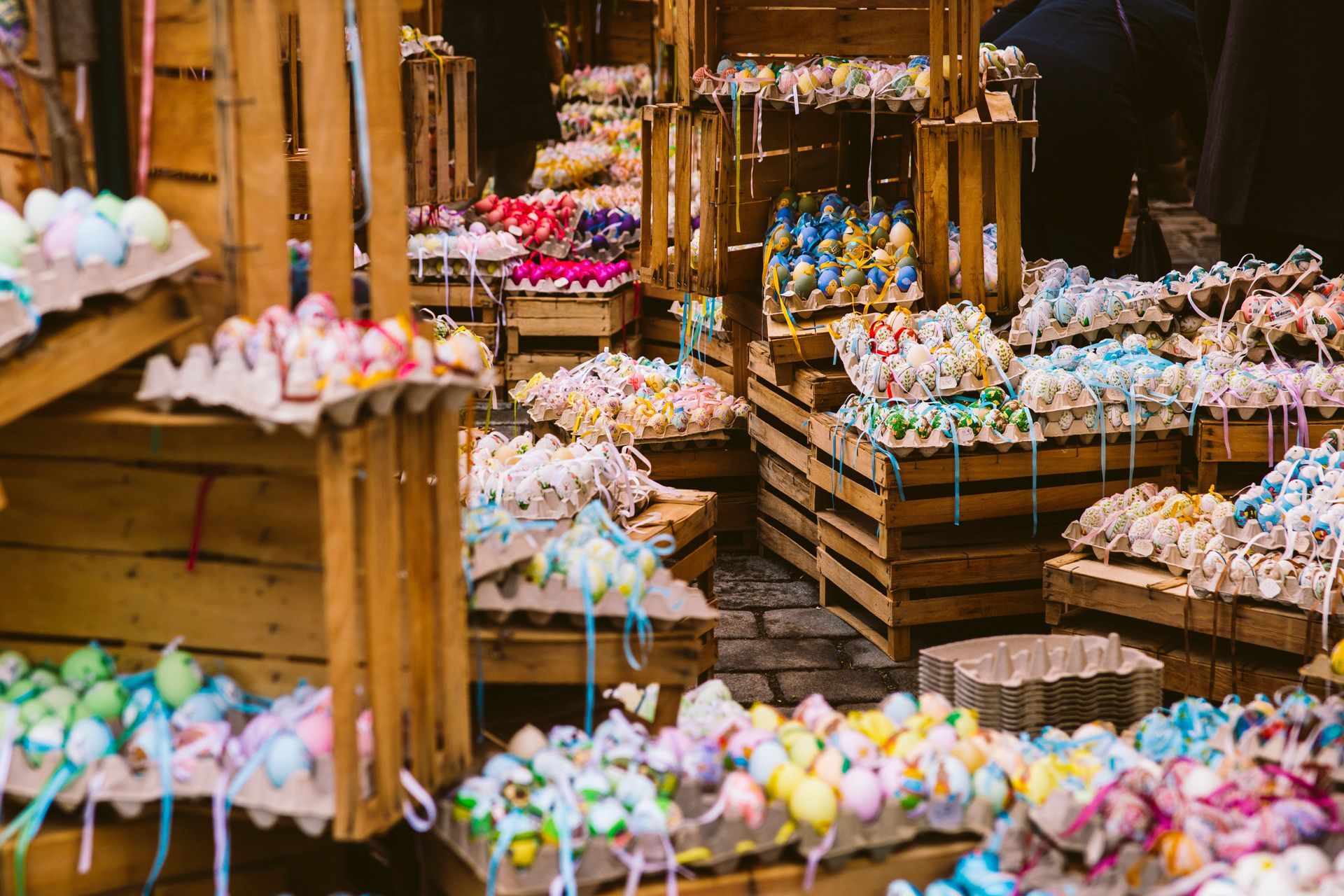A bunch of easter eggs are sitting on top of wooden crates.