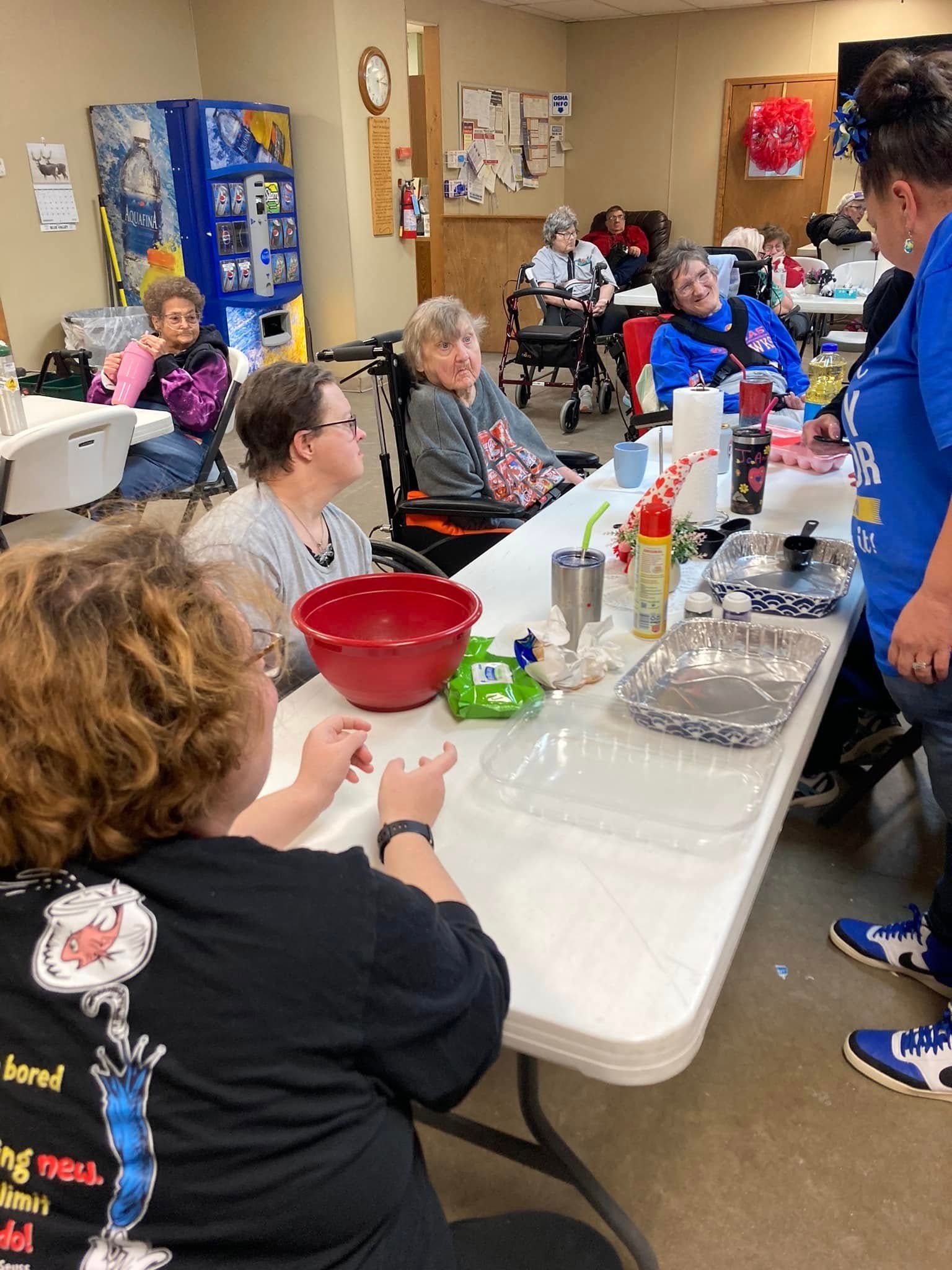 A group of people are sitting at a table in a room.