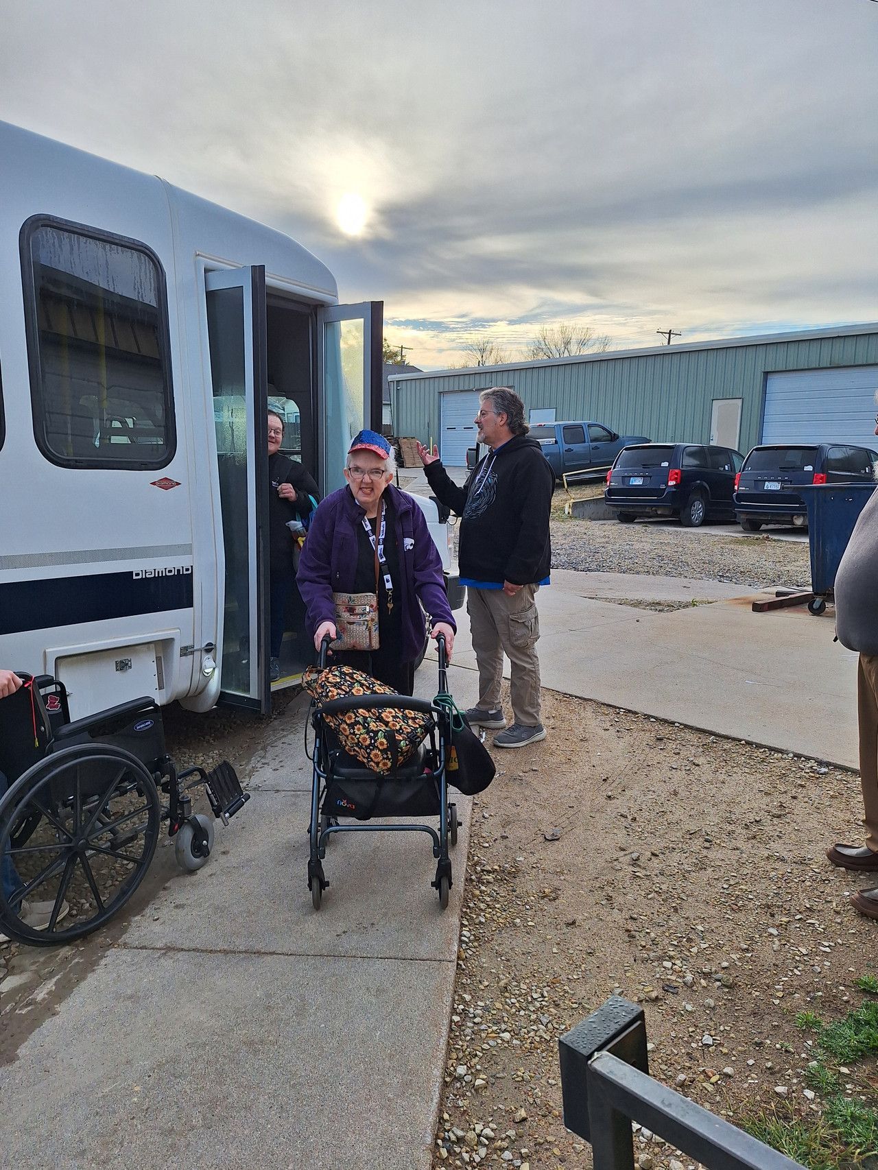 A woman in a wheelchair is getting out of a van.