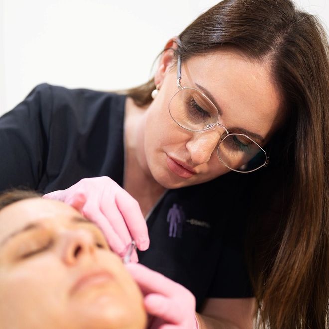 A Woman is Touching a Face of Woman — Coastal Skin & Laser in Tewantin, QLD