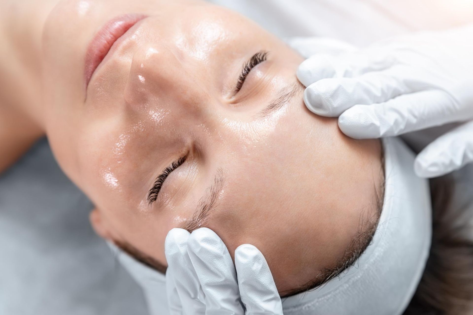 A Woman is Getting a Facial Treatment at a Beauty Salon — Coastal Skin & Laser in Caloundra, QLD
